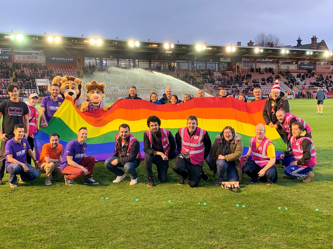 Volunteers with the rainbow flag on the pitch at half-time during the Exeter v Northampton match IMG_4154.jpg